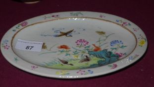 A Chinese Guang Xu oval form dish decorated with geese and foliage