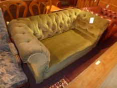 A Victorian drop end chesterfield sofa upholstered in green button back velour raised on turned