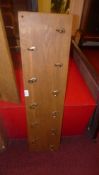 A set of brass oak mounted coat hooks
