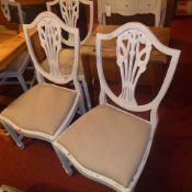 A set of eight Hepplewhite style painted distressed finish dining chairs with drop in seats raised