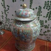 A Chinese famille rose lidded ginger jar decorated with pictoral reserves (heavily restored)