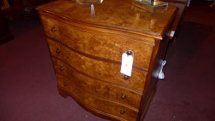 A burr walnut serpentine fronted chest fitted four long drawers on bracket feet