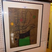 A Joan Miro lithograph in a black frame