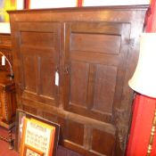 an early C18th oak side cabinet fitted pair of panelled doors enclosing hanging rail on square