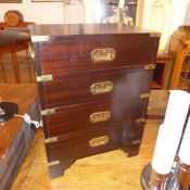 A pair of military mahogany and brass bound bedside chests fitted four drawers with inset handles