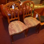A set of four dining chairs with pierced backs above stuffover seats