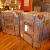 A pair of aluminium and leather bound chests fitted two drawers with strap handles