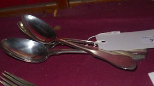 A set of four Russian hallmarked silver fiddle pattern serving spoons with a matching fork