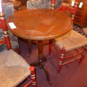 A mahogany wine table the circular top on triform supports