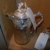 A cut glass and silver plated claret jug with grapevine in relief
