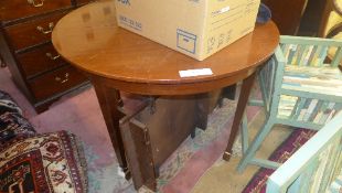 A C19th mahogany D-end dining table with two extra leaves raised on tapered supports