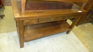 A teak hall table with leather inset top