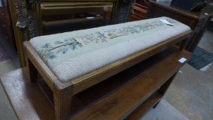 A fender stool with needlework seat on s