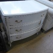 A white painted chest having three drawe