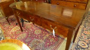 A C20th mahogany serving table the rectangular top above three drawers on tapered supports W 138 D