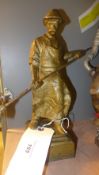 A heavy gilded cast iron figure of a fou