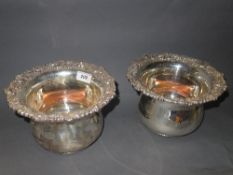 A pair of silver plated wine bottle coas