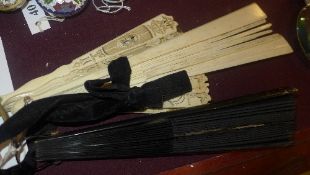 A collection of three fans including two
