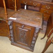 An oak Victorian revival coal scuttle with lion caryatids