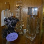 A collection of five perfume bottles