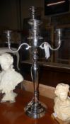 A chromium five light chandelier on step