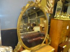 A C19th carved giltwood and gesso overmantel mirror with oval plate and fern leaf relief border