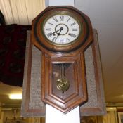 An oak cased wall clock with Roman numer