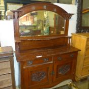 An Arts and Crafts walnut sideboard the