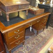 A C20th mahogany partners desk the leather top above drawers and cupboards raised on castors