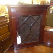 A mahogany corner with glazed panel encl