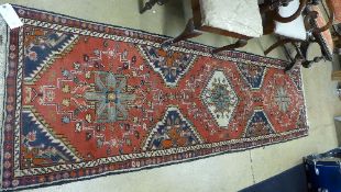 A hand knotted Bokhara rug the terracott