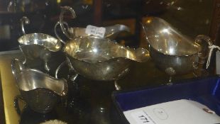 A silver hallmarked gravy boat and four