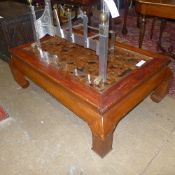 A Chinese lacquered low table with glass