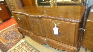 A mid C20th walnut drink cabinet with fa