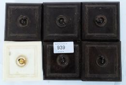 A collection of early 20th century original bakelite switches to include 5 brown examples and one