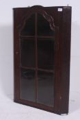 A 19th century walnut hanging corner / display cabinet. The shaped body having full length