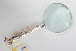 An unusual 20th century silver plated magnifying glass in the form of a bag of golf clubs to the