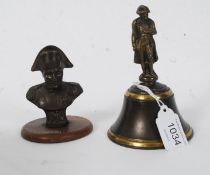 A bronzed miniature bust of Nelson mounted on a wooden base together with a Brass bell with Nelson