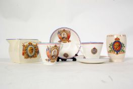 A pair of matching cups and saucers commemorating the Coronation of Edward Vlll along with a water