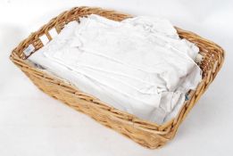 A basket of assorted vintage linens to include night dresses & tablecloths etc