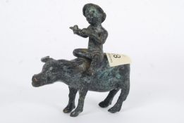 A 19th century bronze figure of a boy riding a Water Buffalo. Chinese. 11cm tall.