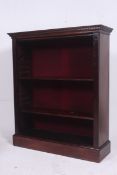 A Victorian large solid mahogany open window bookcase raised on a plinth base with shelves to centre