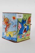 A vintage tin plate Bradbury wind up Tom and Jerry music jack in the box