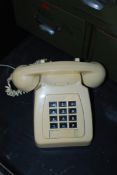 A vintage 1970's cream plastic retro GPO style push button telephone, with black buttons