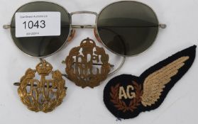 A collection of 2nd world war RAF cap badges together with a pair of aviator pilots sunglasses and a