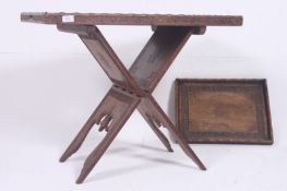 An Islamic hardwood carved detailed Koran stand together with a large gallery tray and another.