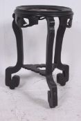 A 19th century Chinese hardwood antique ebonised plant stand raised on shaped supports complete with