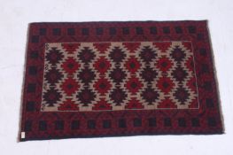 A handwoven Kazak prayer Rug having central diamond lozenges / motifs with red and blue
