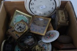 A box of small clocks, movements and parts, mostly 20th century ( see illustration )