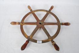 A Mid - 20th century bronze and wood ships wheel, 58cm from point to point.  Provenance; removed